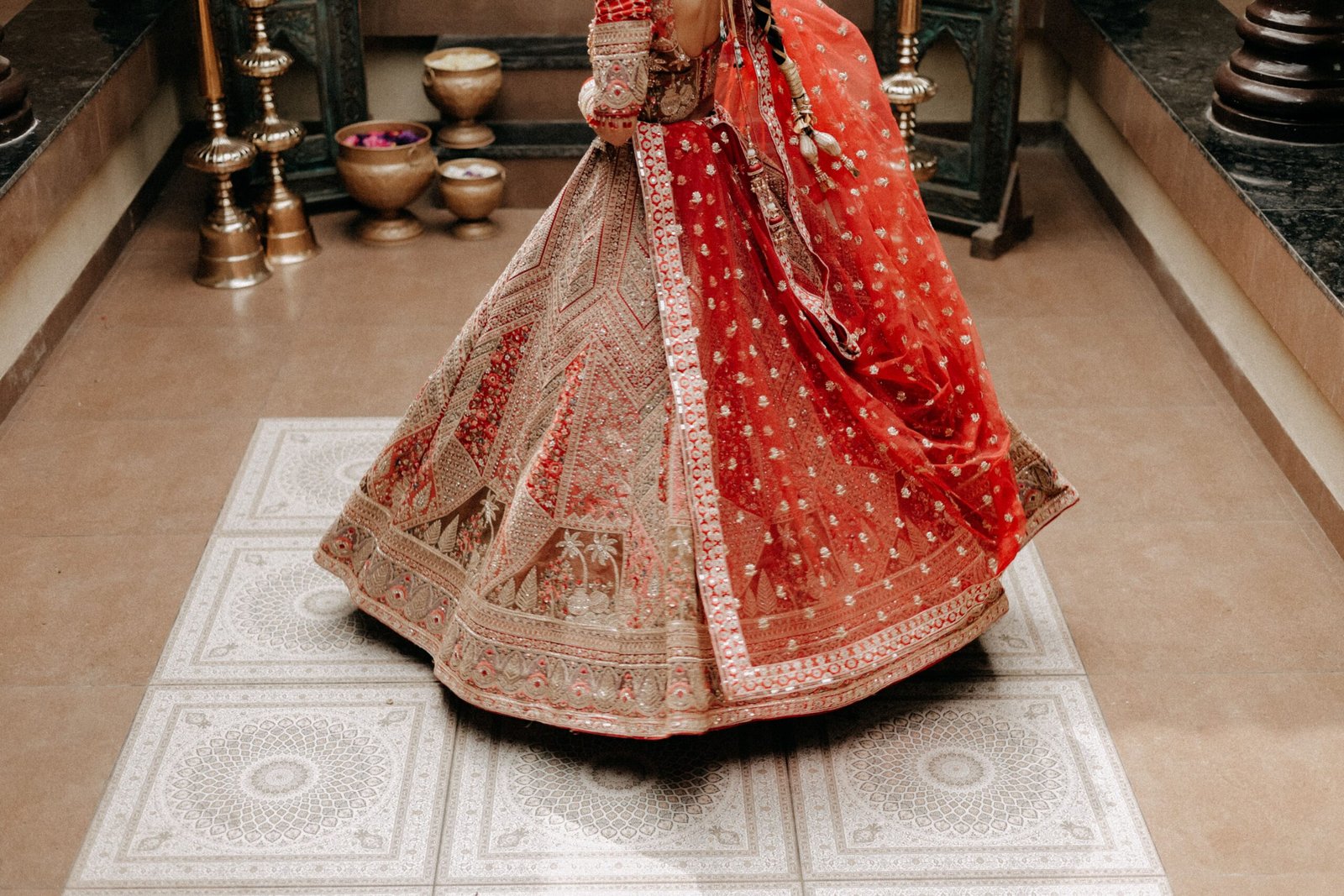 Beautiful close-up of a vibrant red traditional bridal lehenga with intricate embroidery, perfect for wedding themes.